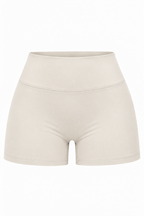 High-waisted seamless athletic shorts in a light cream or off-white color, shown against a plain white background.